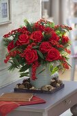 Red winter bouquet with pink 'Orange Sky' (roses), Euphorbia fulgens