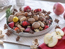 Silver tray filled with walnuts (Juglans), peanuts