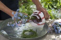 Miniature bouquet of myosotis (forget-me-not) in a florist's tube