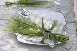Bouquet of Hordeum (barley) as napkin decoration, grass as bow ribbon