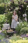 Pregnant woman enjoying the scent in the rose garden