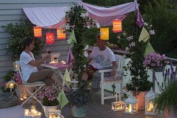 Rosa-weisser Balkon mit Sonnensegel am Abend