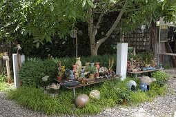 Pottery cats, balls and other decorative elements in garden