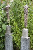 Pottery figures on concrete columns as pedestals