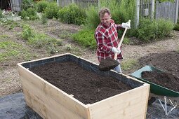 Build a raised flower bed of boards