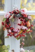 Small wreath of Malus (ornamental apples) and Rosa (roses) at the window