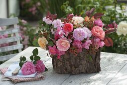 Plastic box with bark glued on as planter box