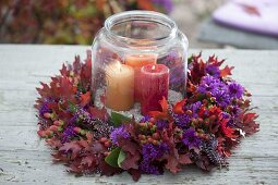 Autumn wreath with violet cushions and red foliage