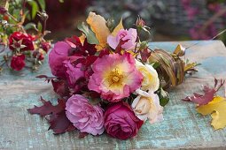Bouquet of pinks (roses) and colourful autumn leaves