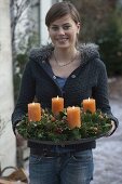 Woman with natural Advent wreath of Abies nordmanniana