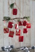 Homemade advent calendar with numbered red paper bags