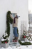 Decorate front door with garland for Christmas