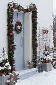 Decorating front door with garland for Christmas