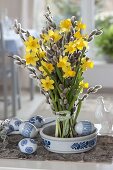Standing bouquet of Narcissus 'Tete a Tete' (daffodils) and Salix