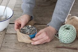 Birdseed in different containers to hang up