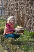 Girl with homemade Easter basket with hare's head as Easter nest