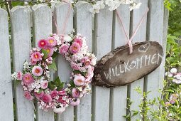 Pink wreath of Bellis (Centaury), Viburnum (Snowball) and Spiraea