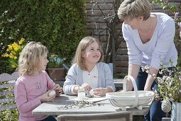 Children making and painting Easter eggs