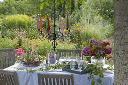 Flower garden table setting under walnut tree
