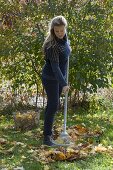 Woman raking leaves