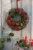 Wreath of round-bent vine of Rosa (Rose), Ilex (holly)