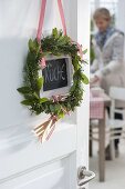 Mediterranean herbs wreath on the kitchen door