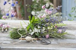 Early summer perennials bouquet lying on the table