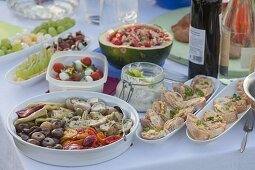 Summer party with friends, table with antipasti and appetizers