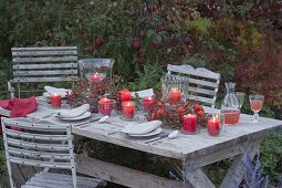 Autumn table decoration with lanterns in wreaths of rose twigs