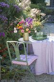 Colorful cottage's garden bouquet on the table at the aster bed