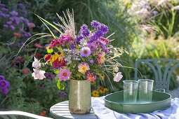 Colorful cottage's garden bouquet on the table at the aster bed