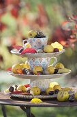 Self-made etagere decorated with plates and coloured cups