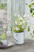 Aqilegia bouquet, grasses and fern leaves in enamelled top