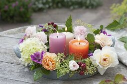 Flower wreath with candles on zinc tray