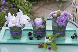 Small table decoration with bouquets and lantern on turquoise coaster