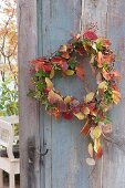 Heart with autumn leaves as a door wreath