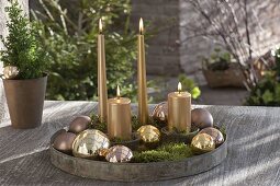 Round metal tray as Advent decoration on patio table