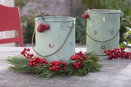 Tin lanterns with Pinus and red berries from Ilex