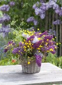 Cottage bouquet made of syringa (lilac), Ranunculus acris