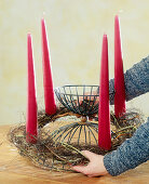 Tying an Advent wreath. Place the finished wreath with the candles on the container.
