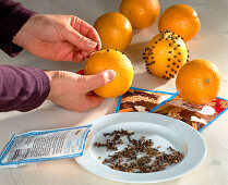 Decorate oranges with carnations Stick carnations in pattern shapes into the oranges