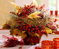 Autumn bouquet with ornamental corn, autumn leaves and berry decorations