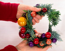 Wreath made of twigs for candle holders. -put coloured balls to the wreath