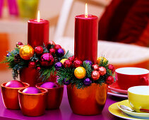 Metallic-red candles, metallic-orange planters, colourful balls, candle rings