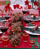Christmas table decoration with garland of Pinus (pine cones), Picea (spruce cones) and fir cones