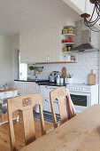 Old chairs at table in country-house kitchen