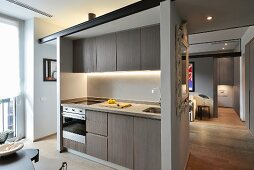 Minimalist fitted kitchen with indirect lighting in apartment