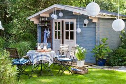 Idyllic seating area with many lanterns in front of summer house