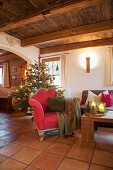 Christmas tree in rustic living room with red and green accents