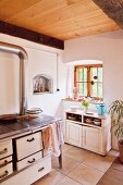 Wood-fired cooker and cabinet in country-house kitchen